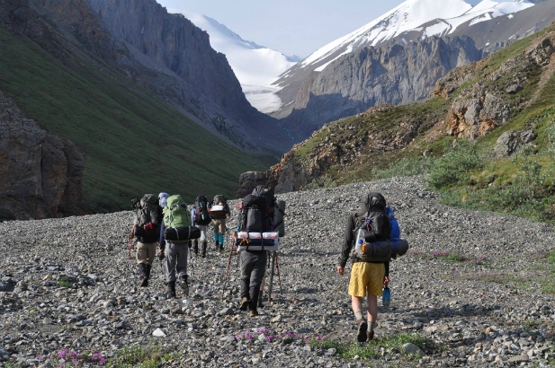 Scouts backpack through alpine passes with nearby glaciers in sight